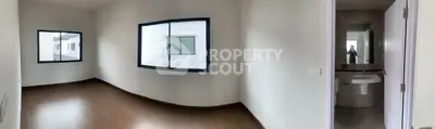 Spacious bedroom with wooden flooring and en-suite bathroom in modern apartment