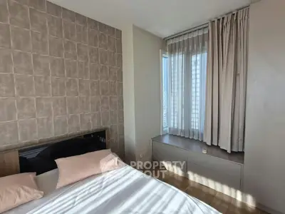 Modern bedroom with stylish decor and ample natural light