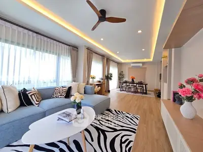 Spacious modern living room with elegant decor and ample natural light.