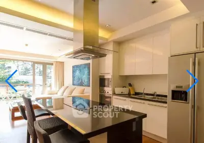 Luxurious open-layout kitchen with modern appliances and spacious living area, perfect for entertaining.
