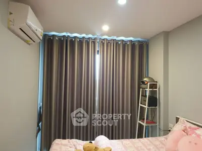 Cozy bedroom with air conditioning and stylish curtains, perfect for relaxation.