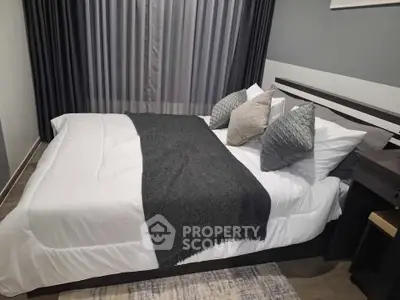 Modern bedroom with stylish decor and cozy bedding in a contemporary apartment.