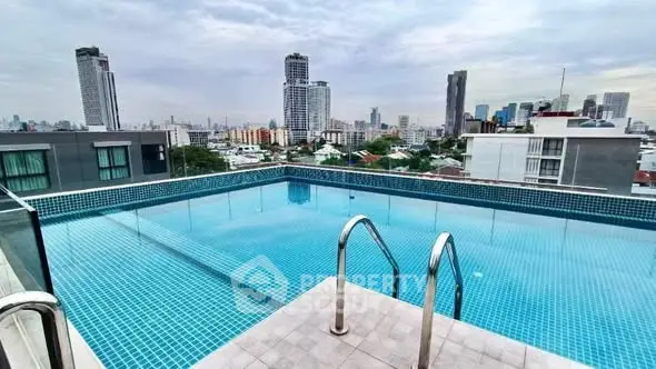 Stunning rooftop pool with panoramic city skyline views, perfect for luxury urban living.