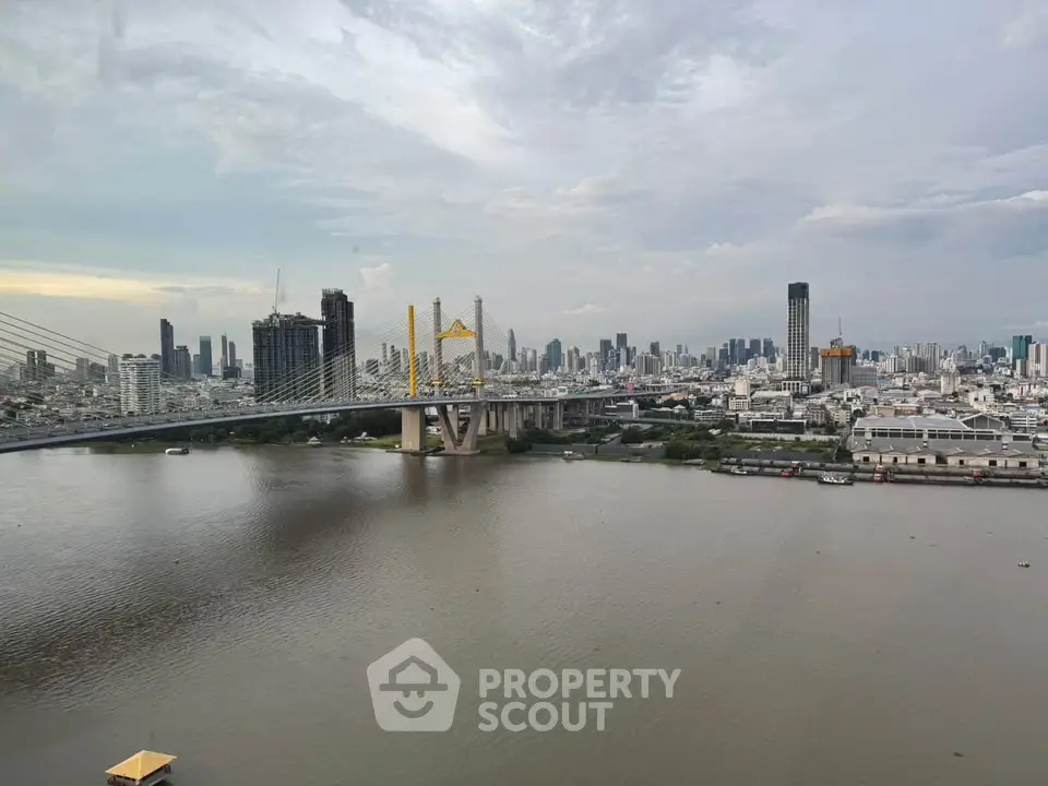 Stunning cityscape view with river and bridge, perfect for urban living enthusiasts.