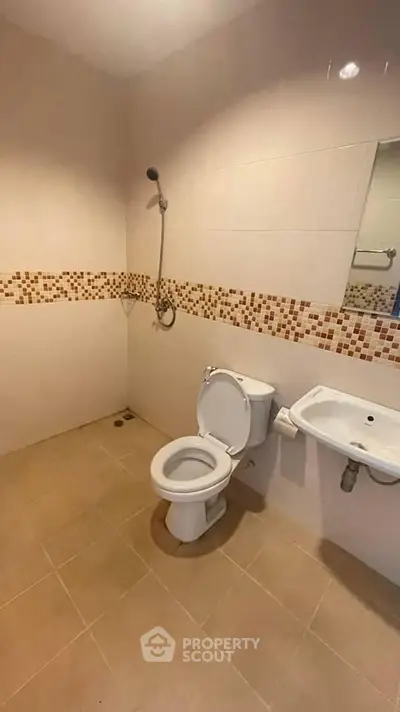 Spacious bathroom with modern fixtures and stylish tile accents.