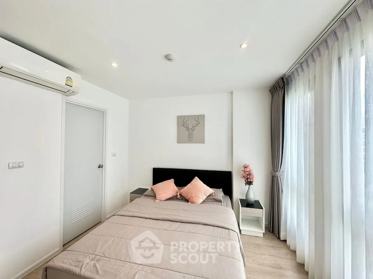 Modern bedroom with natural light, stylish decor, and cozy ambiance.