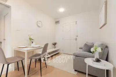 Cozy living room with modern decor and dining area in a bright apartment.