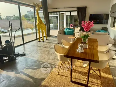 Spacious modern living room with large windows and unique giraffe decor