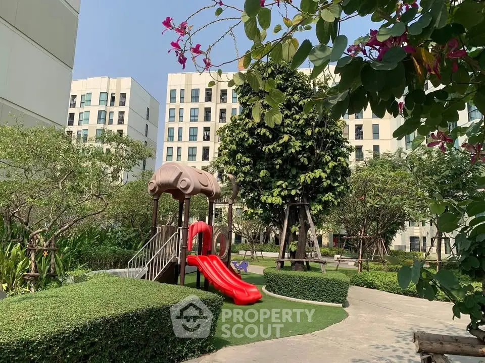 Modern apartment complex with lush garden and children's playground