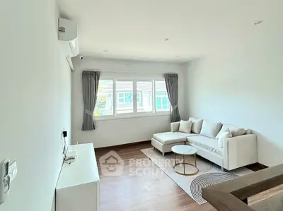 Bright and airy living room with modern decor and large window view.