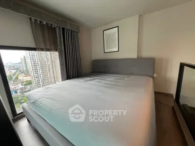 Modern bedroom with city view, featuring a large bed and stylish decor.