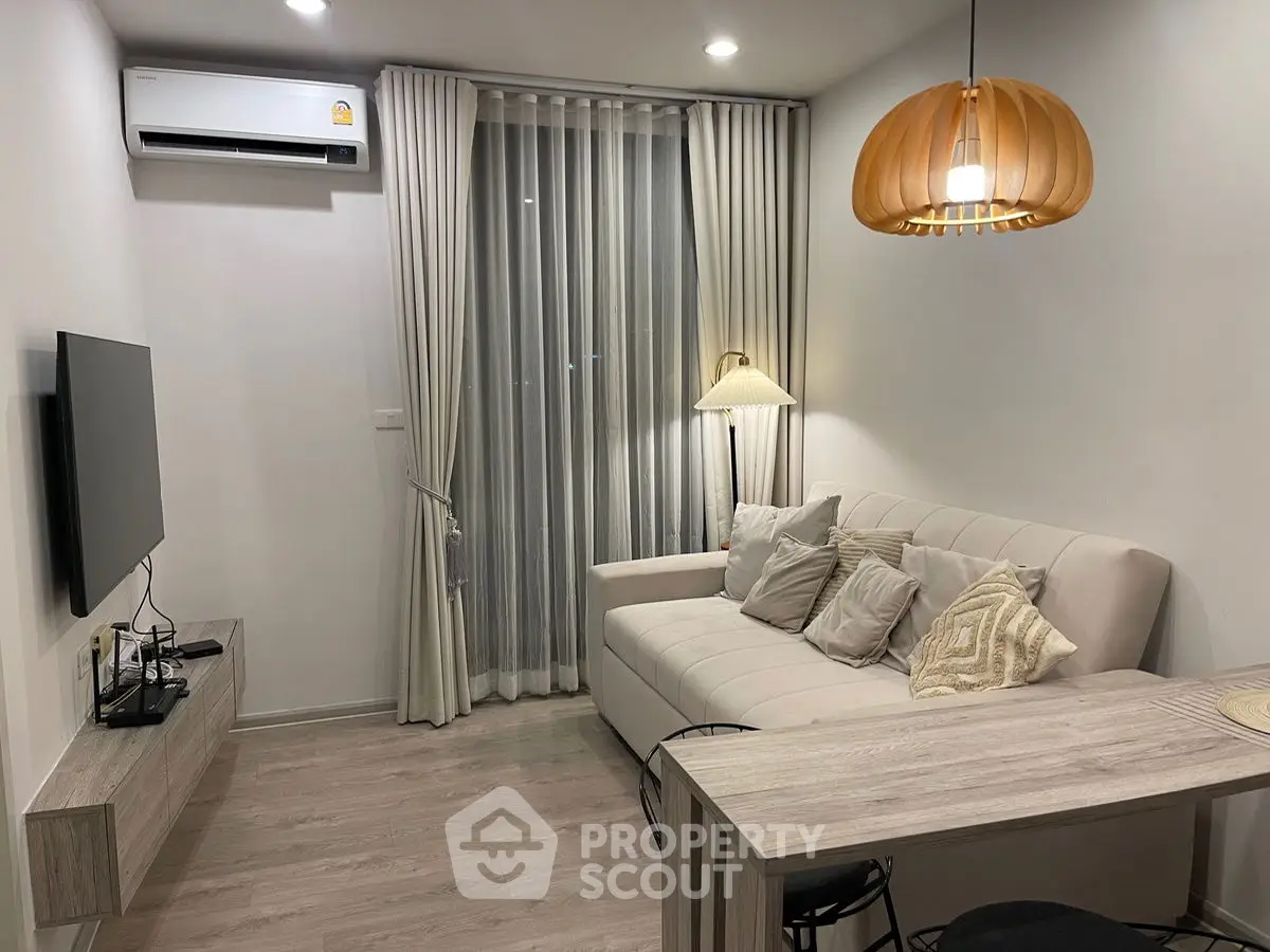Modern living room with cozy sofa, stylish lighting, and sleek TV setup.