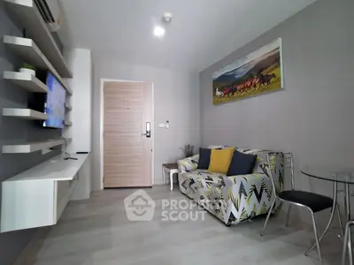 Modern living room with stylish decor and wall art, featuring a cozy sofa and sleek shelving.