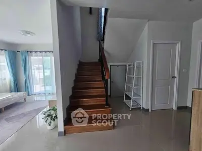 Spacious modern interior with wooden staircase and bright living area
