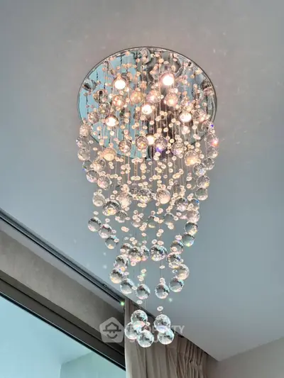 Elegant crystal chandelier in modern interior with natural light