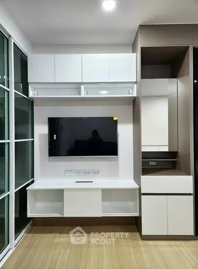 Modern living room with sleek TV unit and ample storage space