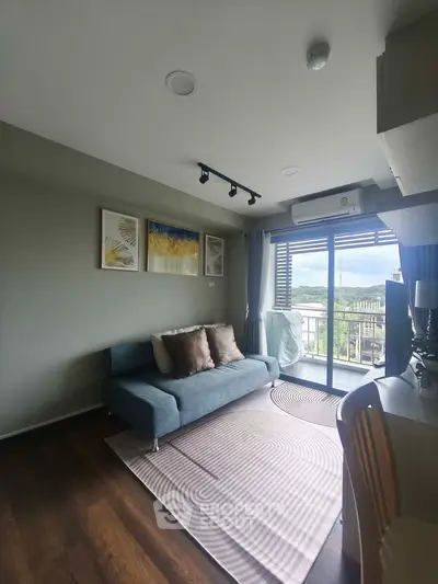 Modern living room with stylish decor and balcony view, featuring a cozy sofa and elegant artwork.
