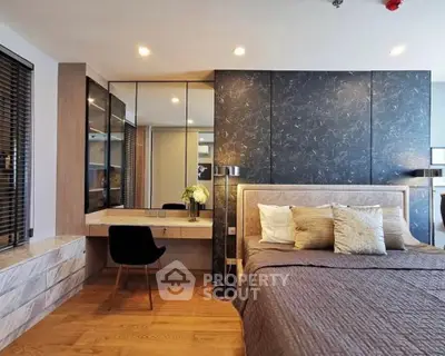 Luxurious modern bedroom with elegant decor and stylish furnishings, featuring a cozy bed and chic vanity area.