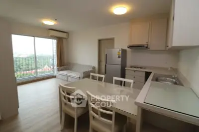 Modern open-layout kitchen and living area with scenic balcony view