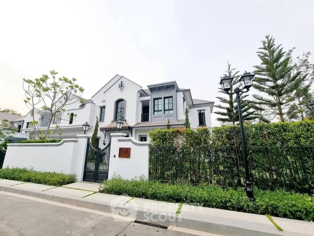 Elegant white house with lush greenery and classic architecture