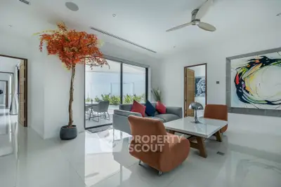 Modern living room with stylish decor and large windows opening to a patio.