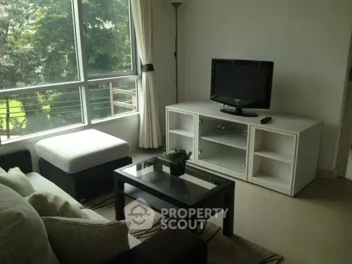 Cozy living room with modern furniture and large window view.