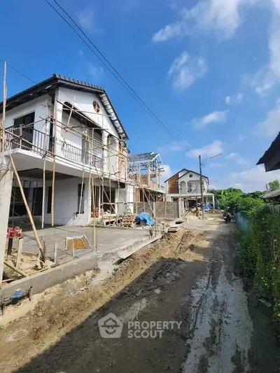 Newly constructed houses on a sunny day, showcasing modern architecture and spacious layout.