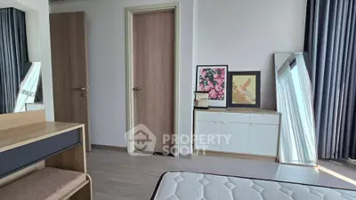 Modern bedroom with stylish decor, featuring a comfortable bed, elegant curtains, and chic artwork.