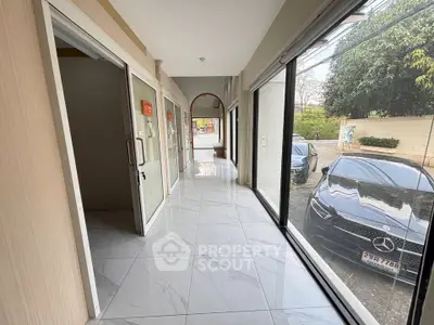 Spacious commercial property with large windows and ample parking space, ideal for business opportunities.