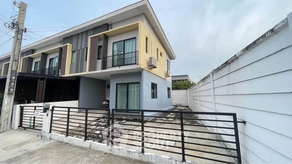 Modern two-story townhouse with sleek design and spacious driveway