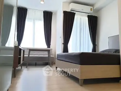 Modern bedroom with large windows, stylish curtains, and sleek furniture in a bright apartment.