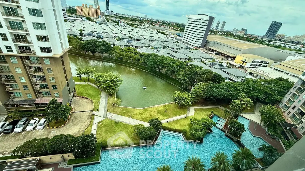 Stunning aerial view of modern apartment complex with pool and lush greenery, perfect urban living.