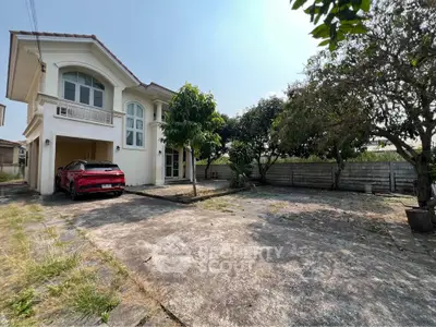 Charming two-story house with spacious driveway and lush garden