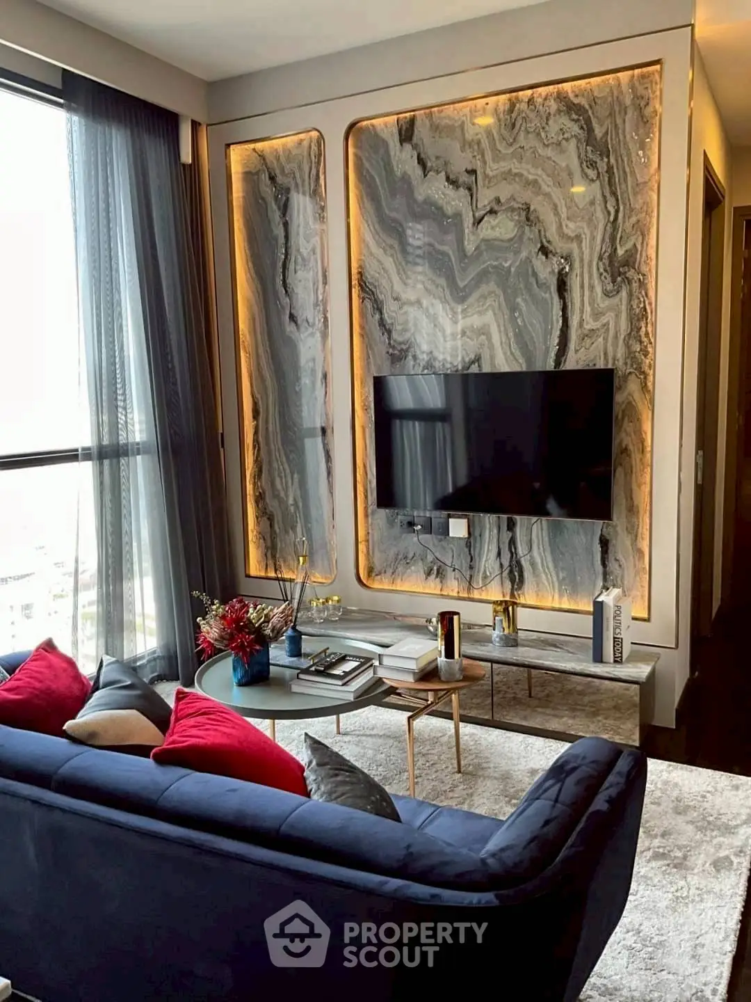 Luxurious living room with marble accent wall and modern decor