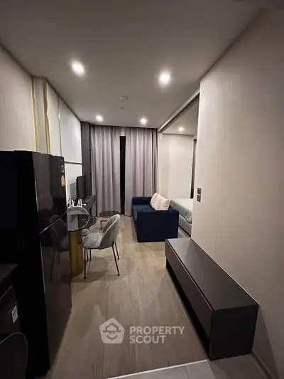 Modern studio apartment with sleek furnishings and open layout, featuring a cozy living area and stylish decor.