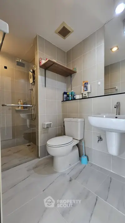 Modern bathroom with sleek fixtures and spacious shower area.