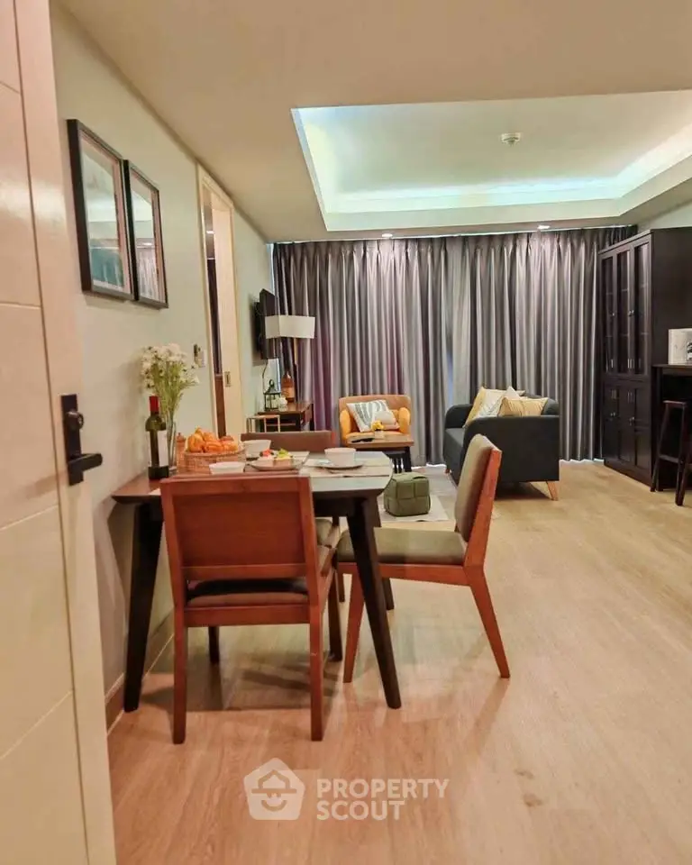 Modern living room with dining area, featuring stylish furniture and elegant decor.