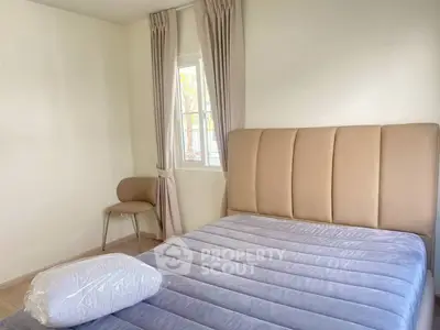 Cozy minimalist bedroom with plush bed and natural light