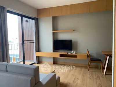 Modern living room with sleek furniture and balcony access