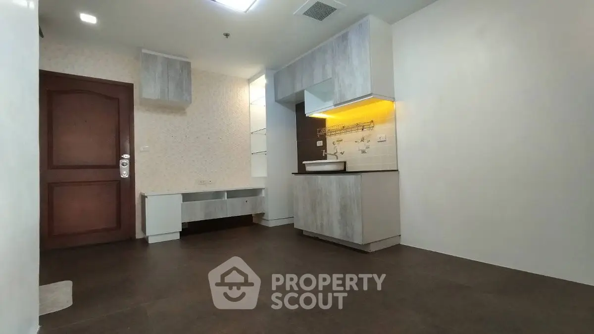 Modern kitchen with sleek cabinetry and ambient lighting in a stylish apartment.