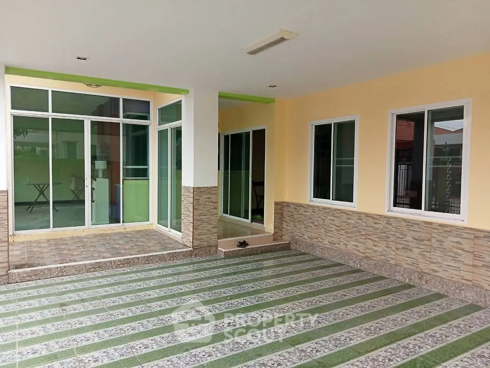 Spacious modern home entrance with tiled flooring and large windows