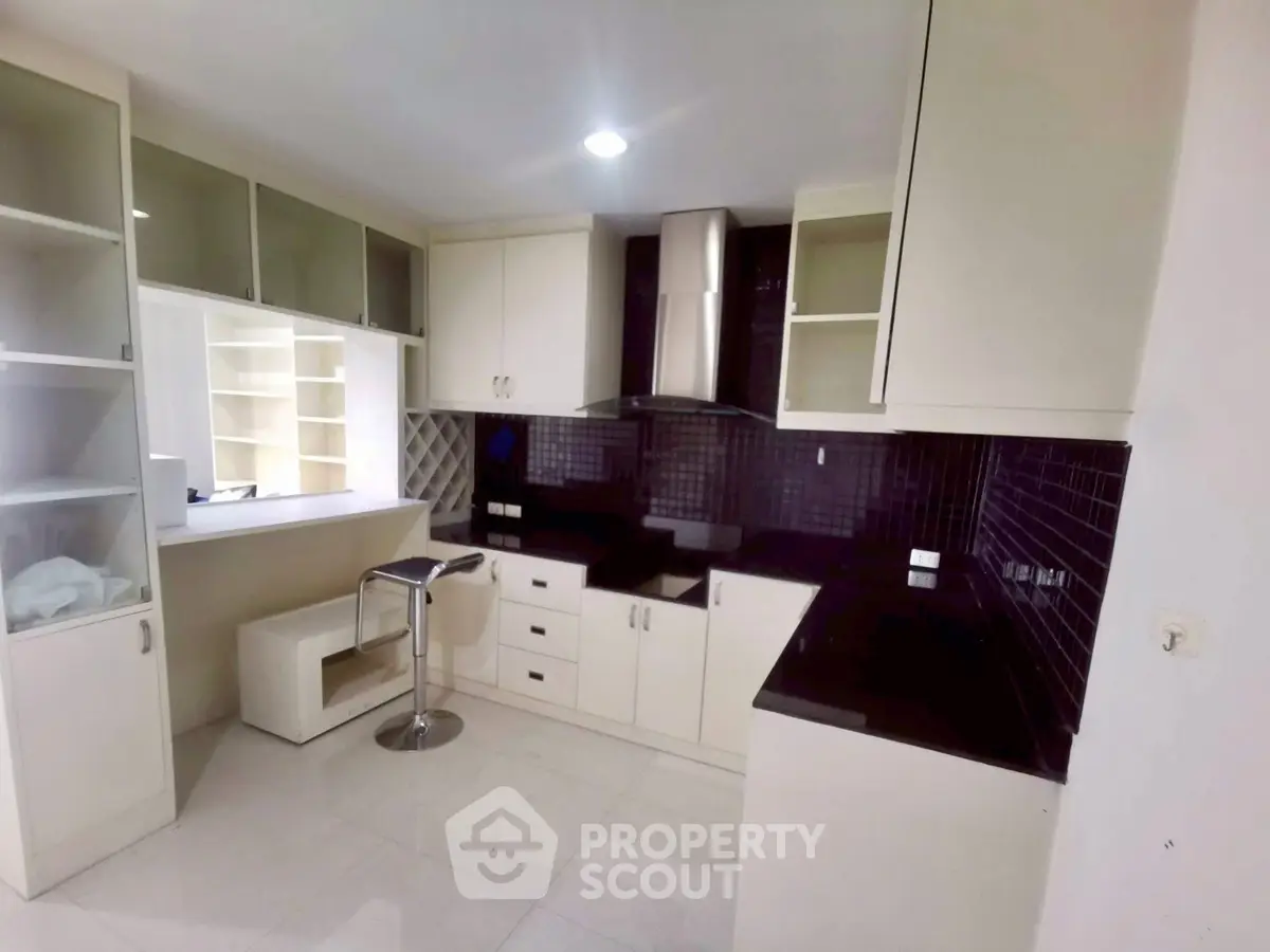 Modern kitchen with sleek black countertops and ample storage space