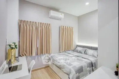 Cozy modern bedroom with air conditioning and stylish decor