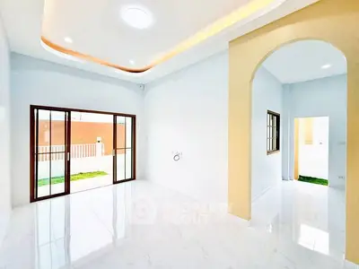 Spacious modern living room with elegant archway and sliding glass doors