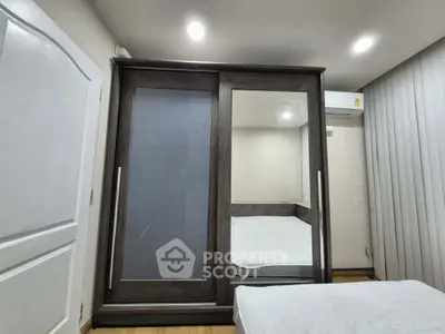 Modern bedroom with sleek wardrobe and cozy bed setup