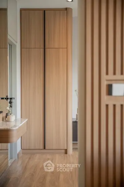 Modern wooden wardrobe in stylish interior with elegant decor