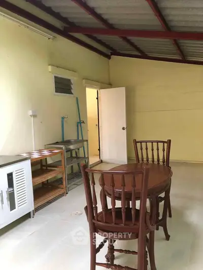 Spacious kitchen area with wooden dining set and open layout, ideal for family gatherings.