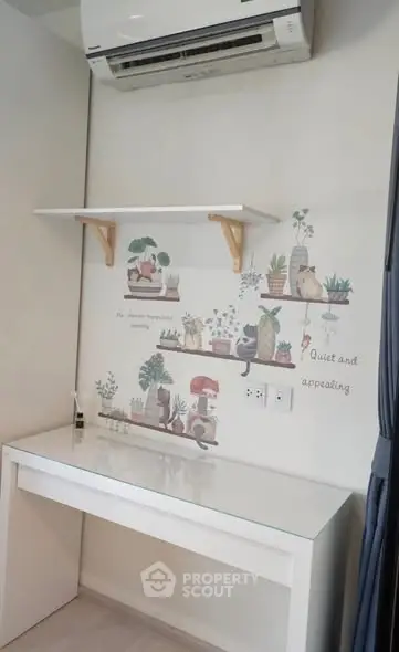 Charming study nook with wall art and air conditioning, perfect for a peaceful workspace.