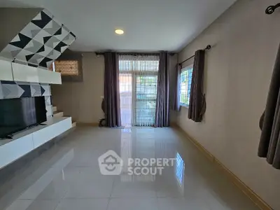 Spacious living room with modern design and large windows for natural light.