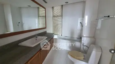 Spacious bathroom with modern fixtures and large mirror in elegant home.